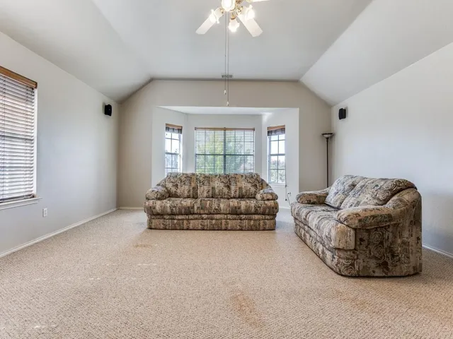 a living room with furniture and a chandelier