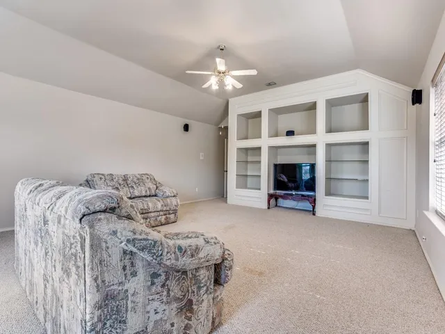 a bedroom with bed and a chandelier