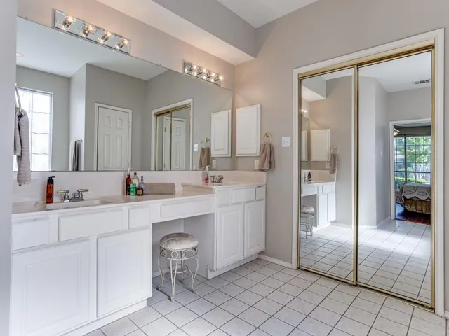 a spacious bathroom with a double vanity sink mirror and