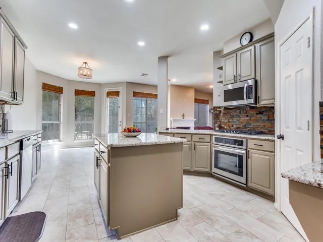 a kitchen with stainless steel appliances granite countertop a stove and a sink