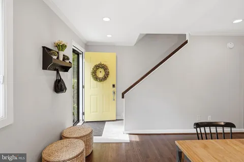 a view of entryway and hall with wooden floor