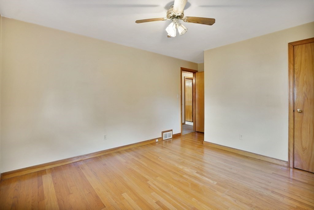 38 Dillon Street Chicopee, MA 01013 - Photo 17 of 19 an empty room with wooden floor fan and windows