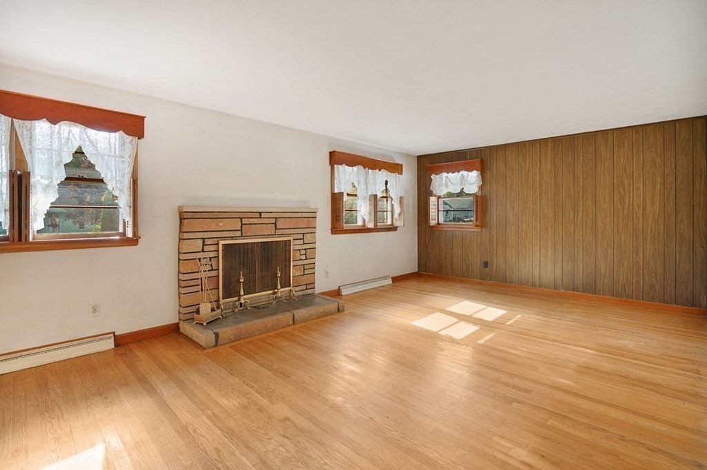 38 Dillon Street Chicopee, MA 01013 - Photo 8 of 19 an empty room with windows and fireplace