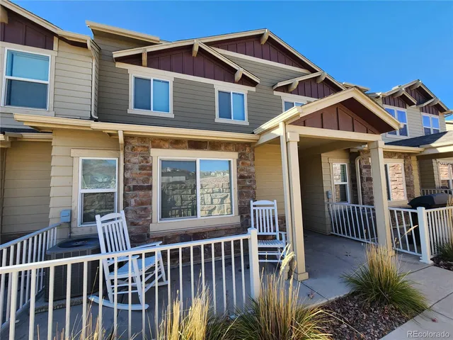 a view of a house with a small deck