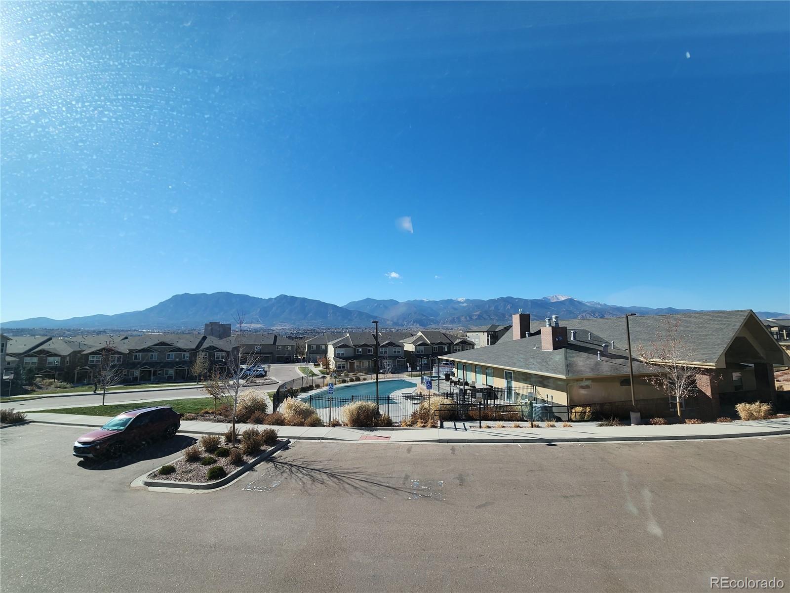 2118 Birmingham Loop Colorado Springs, CO 80910 - Photo 19 of 20 a roof deck with table and chairs a barbeque