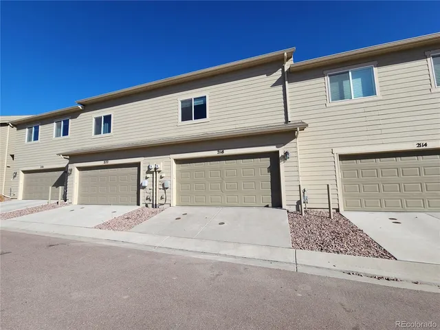 a front view of a house with garage