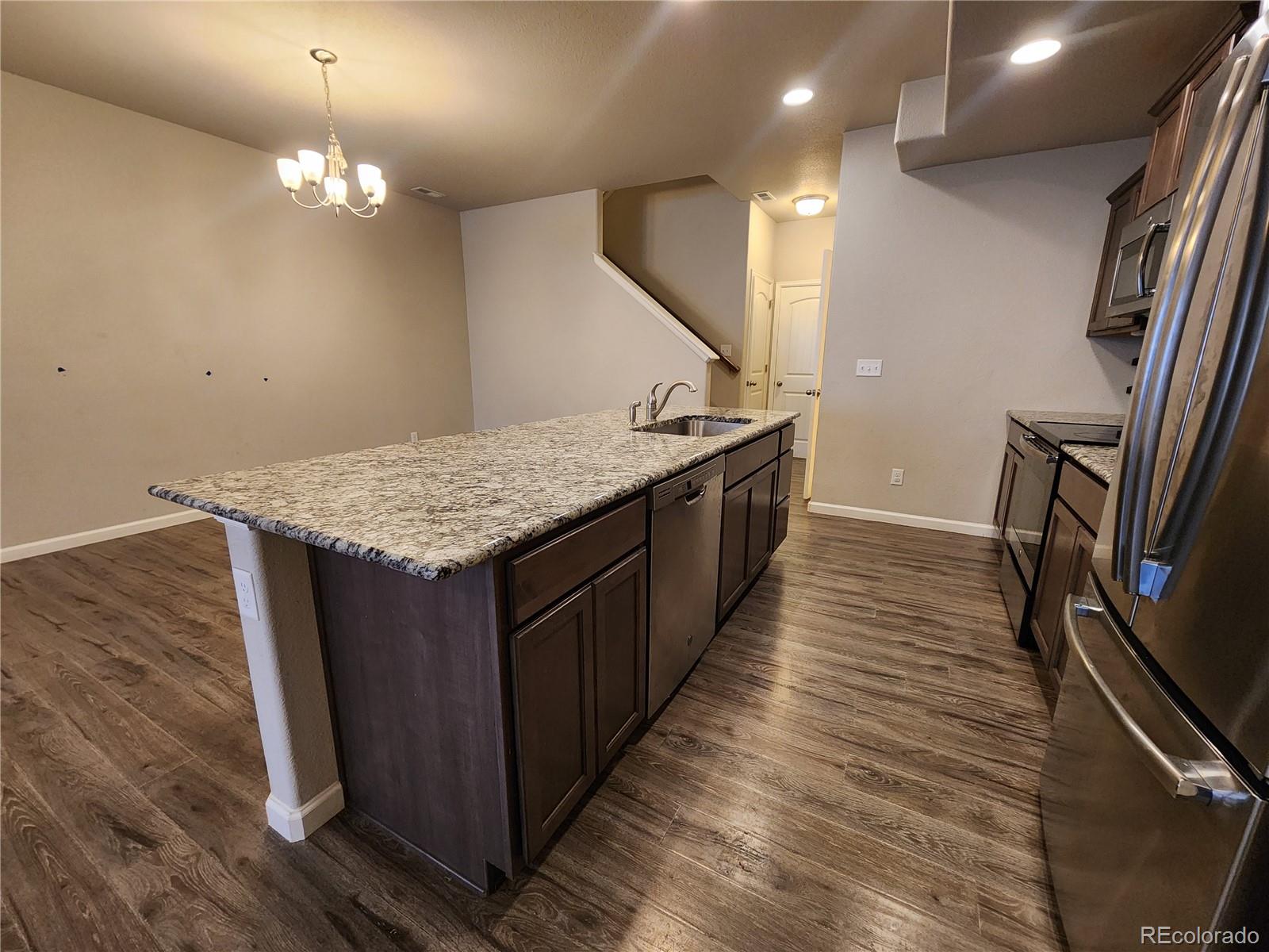 2118 Birmingham Loop Colorado Springs, CO 80910 - Photo 8 of 20 a kitchen with sink cabinets and wooden floor