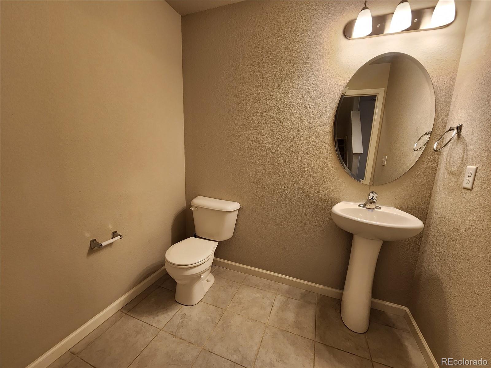 2118 Birmingham Loop Colorado Springs, CO 80910 - Photo 9 of 20 a bathroom with a toilet sink and mirror