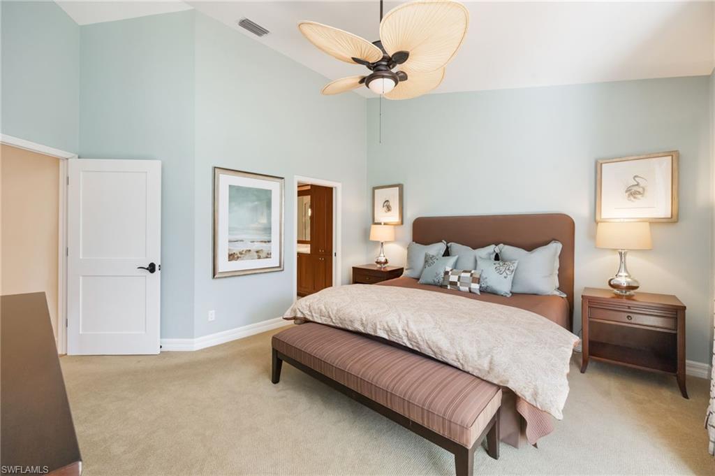 611 10th Avenue South, Unit B2 Naples, FL 34102 - Photo 18 of 27 Bedroom featuring high vaulted ceiling, light colored carpet, ensuite bathroom, and ceiling fan