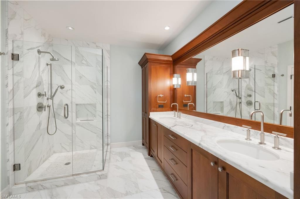 611 10th Avenue South, Unit B2 Naples, FL 34102 - Photo 19 of 27 Bathroom with double vanity, a marble finish shower, and light marble finish floors