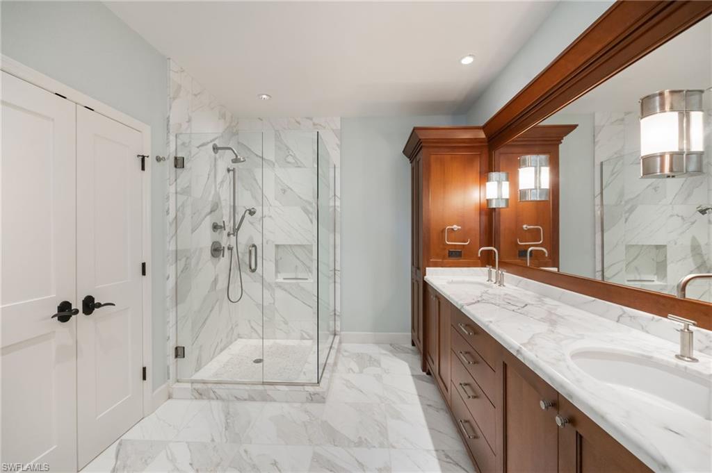 611 10th Avenue South, Unit B2 Naples, FL 34102 - Photo 20 of 27 Bathroom featuring double vanity, a marble finish shower, and light marble finish floors