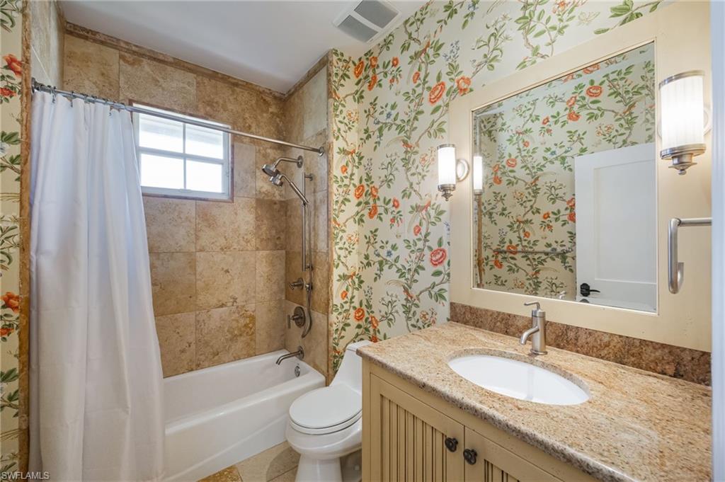 611 10th Avenue South, Unit B2 Naples, FL 34102 - Photo 22 of 27 Full bath with wallpapered walls, vanity, and shower / bath combo