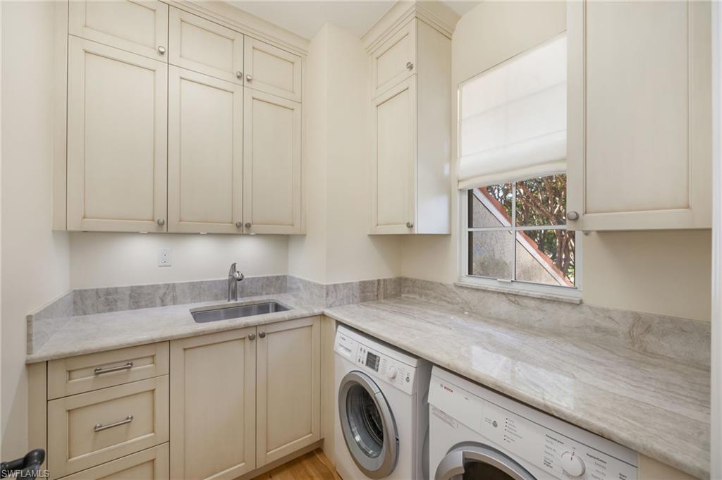 611 10th Avenue South, Unit B2 Naples, FL 34102 - Photo 23 of 27 Washroom with cabinet space and washer and dryer