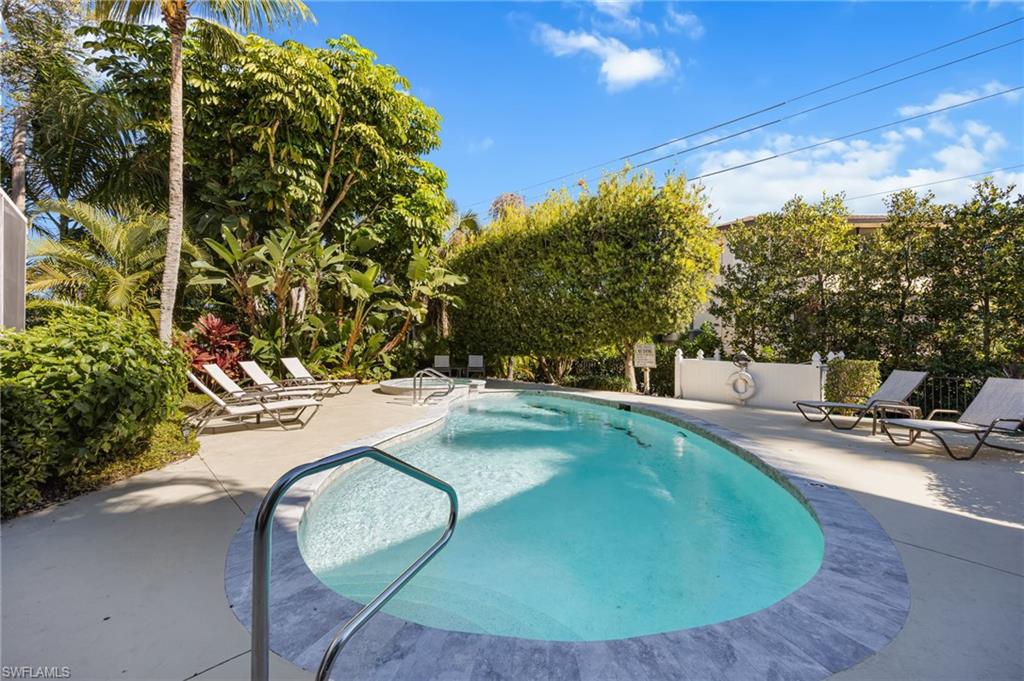 611 10th Avenue South, Unit B2 Naples, FL 34102 - Photo 26 of 27 Community pool with a patio area