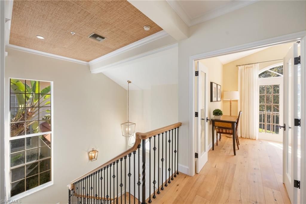 611 10th Avenue South, Unit B2 Naples, FL 34102 - Photo 5 of 27 Hall with wood-type flooring, ornamental molding, healthy amount of natural light, a chandelier, and french doors