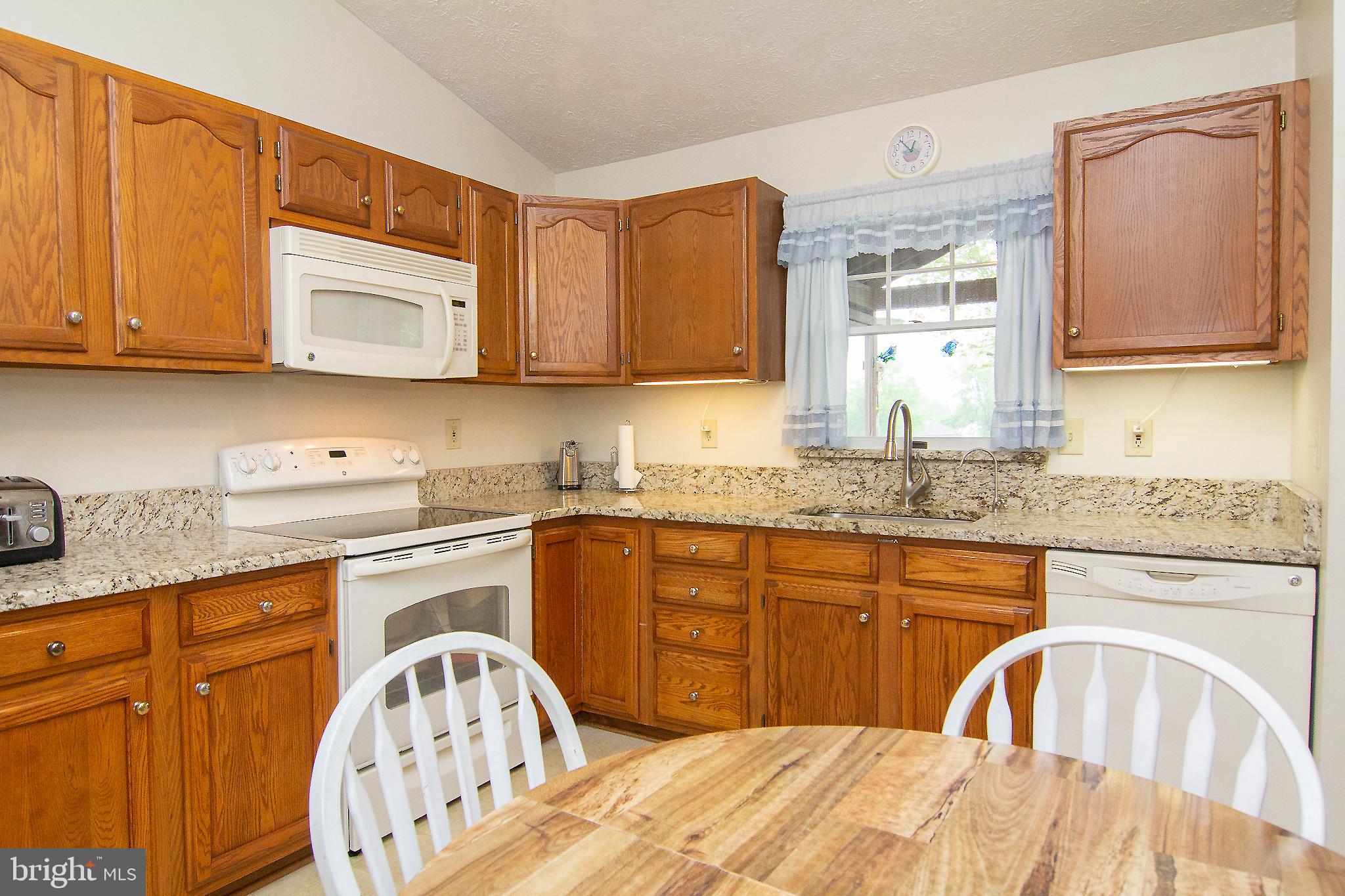 6683 Slacks Road Eldersburg, MD 21784 - Photo 9 of 37 Plenty of oak cabinets w/ window for natural light