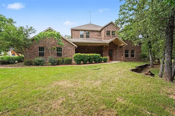 a front view of house with yard and green space