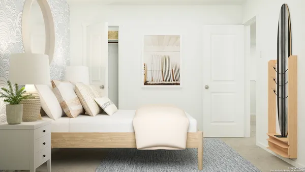 a bedroom with a bed and a painting on the wall