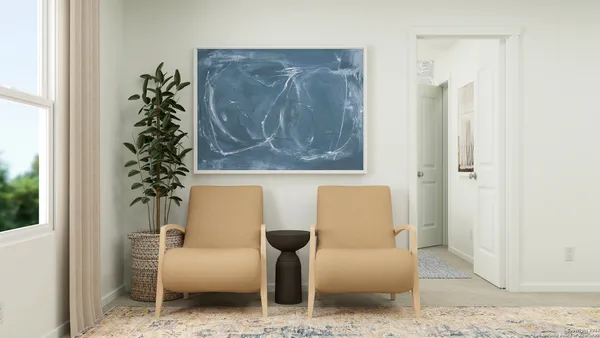 a living room with furniture and a potted plant