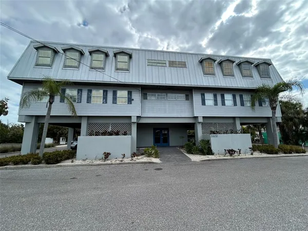 a front view of a building with parking