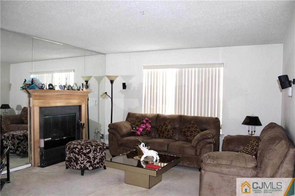 98 Prestwick Way Edison, NJ 08820 - Photo 2 of 16 a living room with furniture and a fireplace