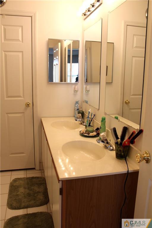 98 Prestwick Way Edison, NJ 08820 - Photo 15 of 16 a bathroom with a sink and a mirror