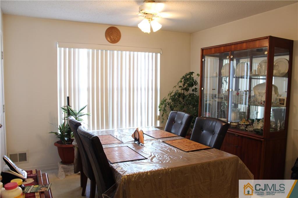 98 Prestwick Way Edison, NJ 08820 - Photo 4 of 16 a bedroom with a bed and a table