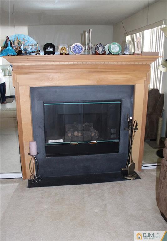98 Prestwick Way Edison, NJ 08820 - Photo 5 of 16 a living room with a fireplace