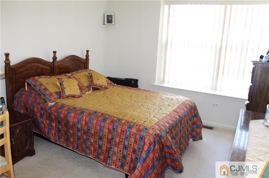 98 Prestwick Way Edison, NJ 08820 - Photo 7 of 16 a bedroom with a bed and a window