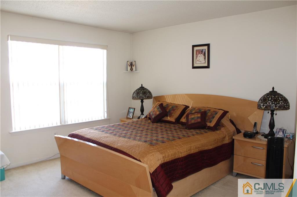 98 Prestwick Way Edison, NJ 08820 - Photo 10 of 16 a bedroom with a bed and cabinets