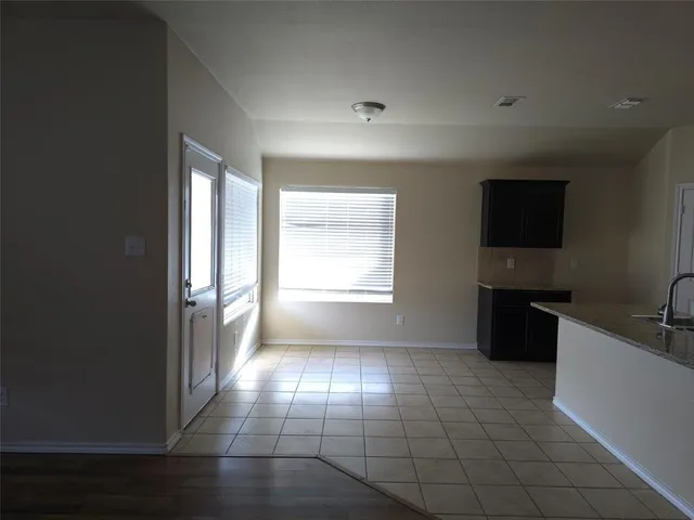 a view of wooden floor and windows in an empty room