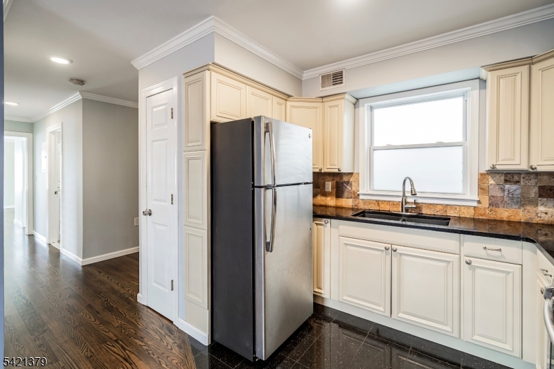 312 Vine Street, Unit 1 Elizabeth, NJ 07202 - Photo 2 of 6 a kitchen with stainless steel appliances granite countertop a refrigerator and a sink