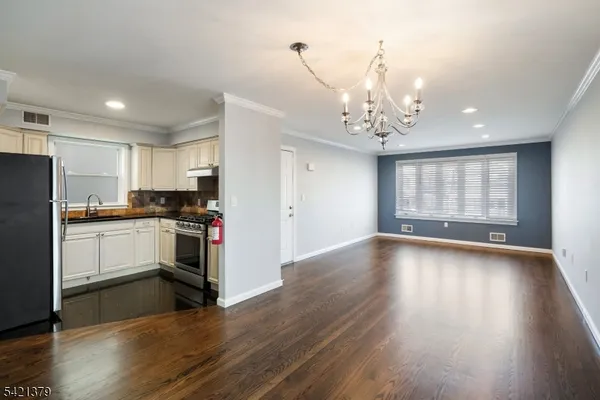 a kitchen with a refrigerator and a stove top oven