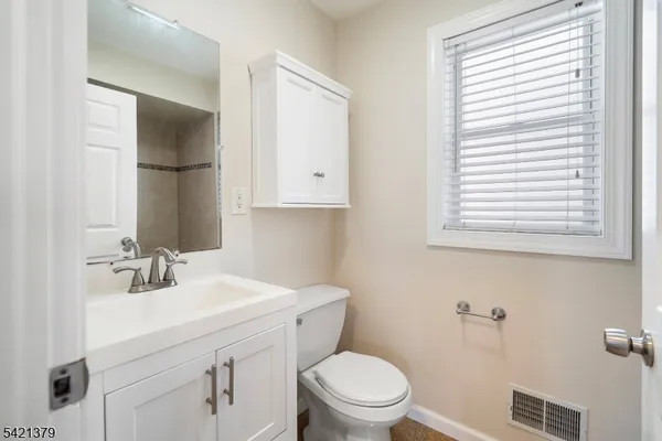 a bathroom with a sink toilet and mirror