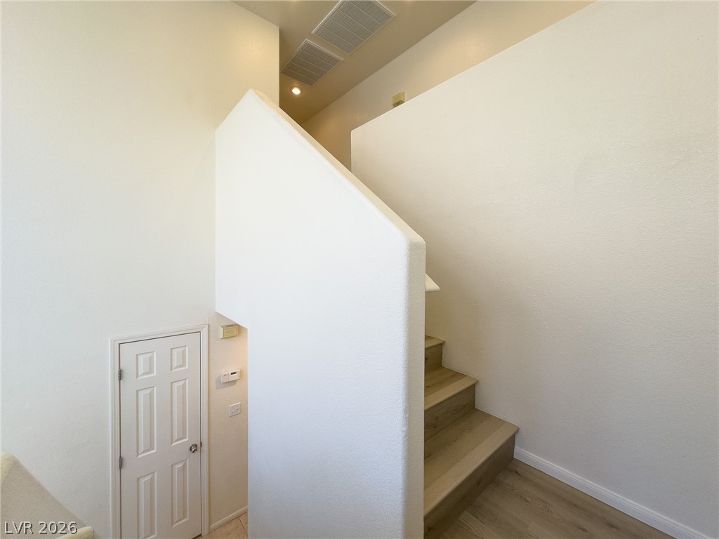 9456 Grandview Spring Avenue Las Vegas, NV 89166 - Photo 19 of 49 Clean lines define this bright stairwell, creating a seamless transition between levels.