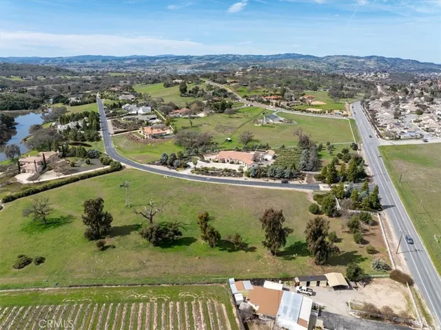 an aerial view of a house with a garden and lake view