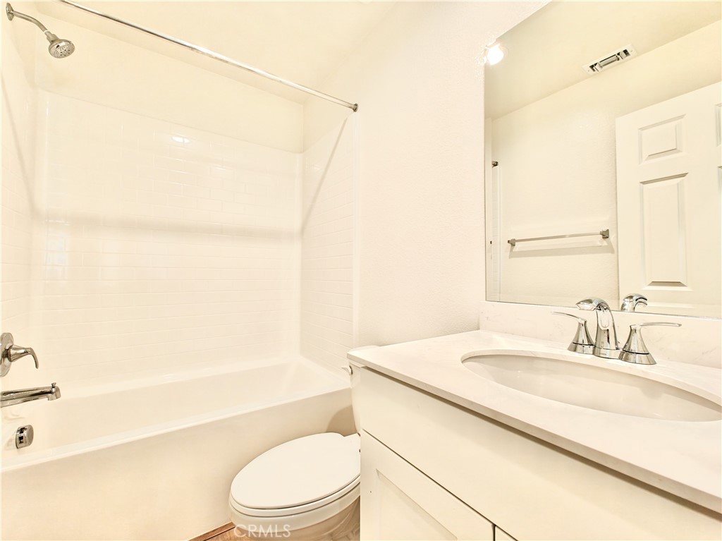 20055 Lemonscent Drive Riverside, CA 92507 - Photo 16 of 19 a bathroom with a granite countertop sink toilet and shower
