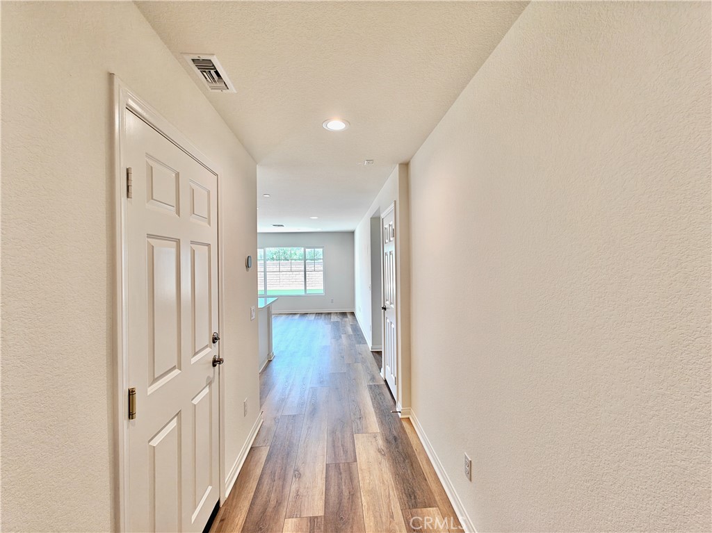20055 Lemonscent Drive Riverside, CA 92507 - Photo 3 of 19 a view of a hallway with wooden floor and entryway