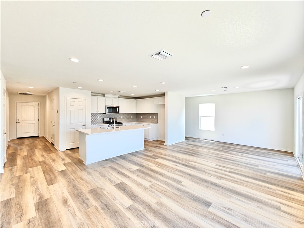 20055 Lemonscent Drive Riverside, CA 92507 - Photo 6 of 19 a large kitchen with kitchen island a sink stainless steel appliances and cabinets