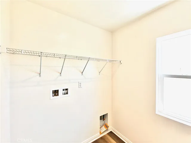 a view of a white wall and a window