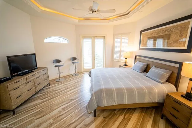 a bedroom with a bed and a chandelier