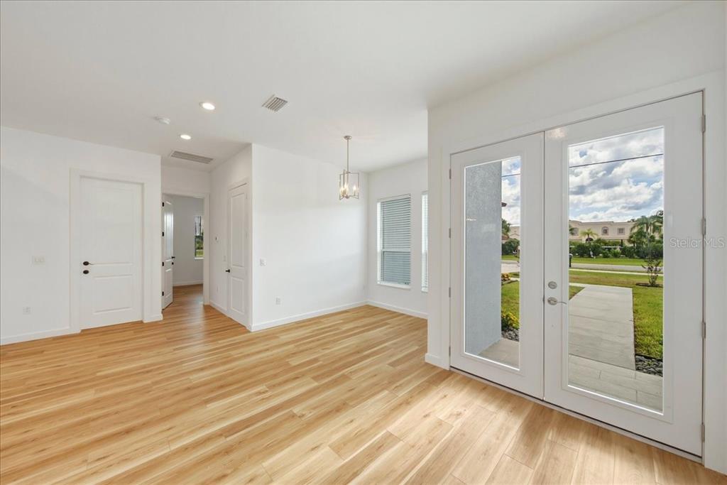 1215 Rio De Janeiro Avenue Punta Gorda, FL 33983 - Photo 42 of 65 a view of empty room with wooden floor and fan