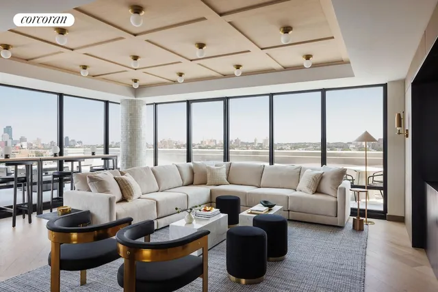 a living room with lots of furniture and a large window