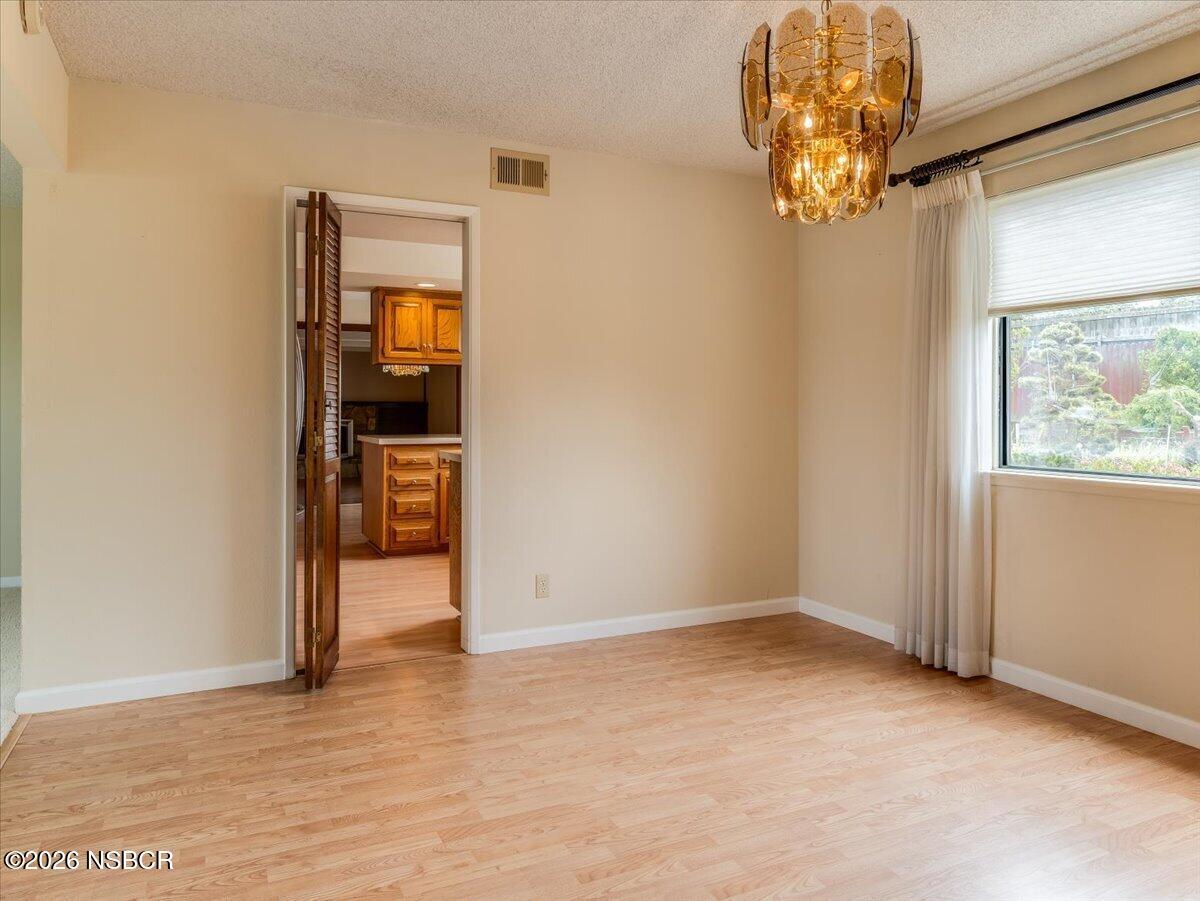 360 Tallyho Road Santa Maria, CA 93455 - Photo 15 of 72 an empty room with chandelier fan and windows