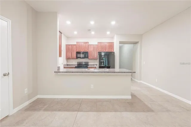 a view of kitchen cabinets and chandelier