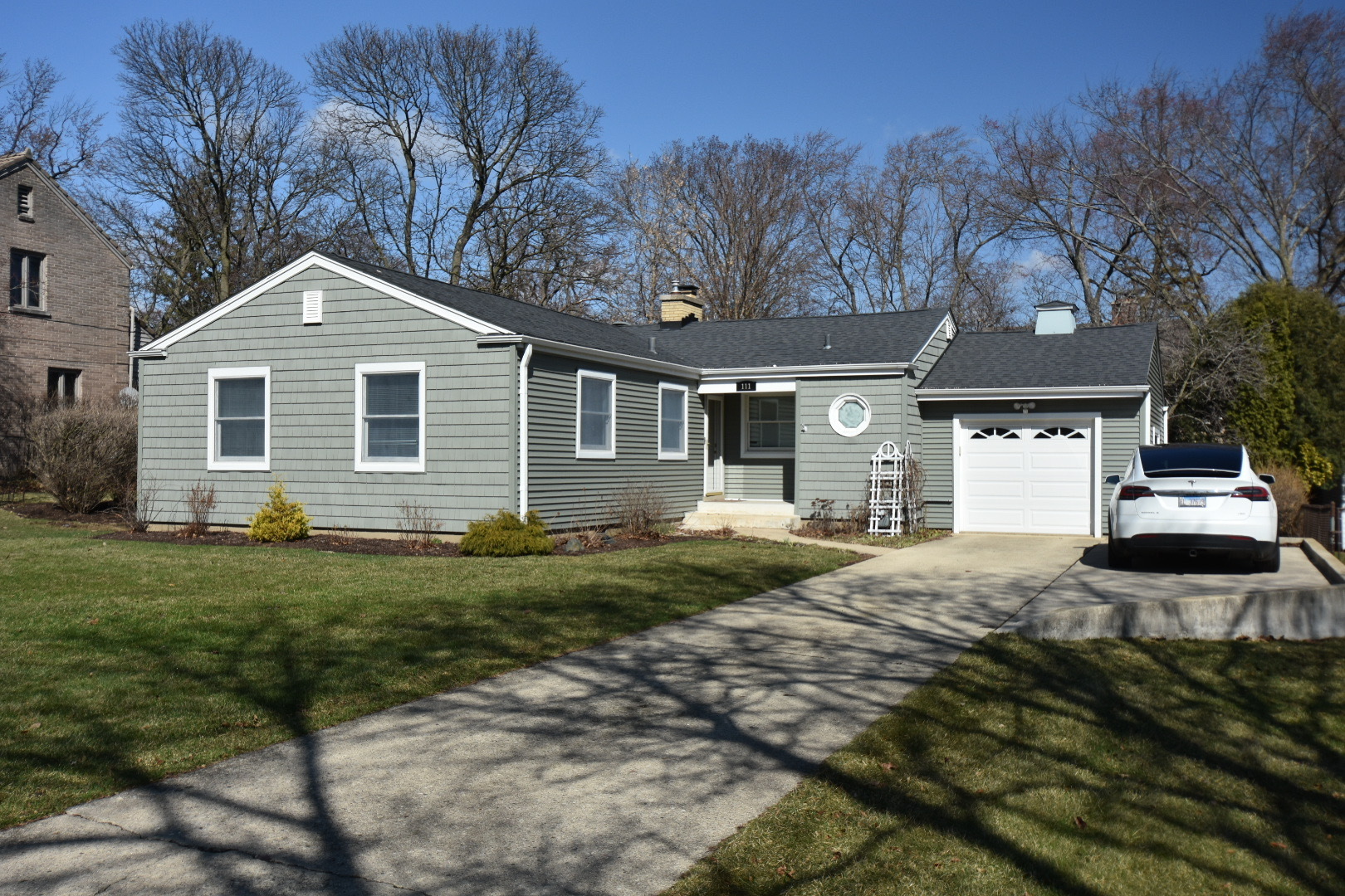 111 West Prairie Avenue Wheaton, IL 60187 - Photo 1 of 24 a front view of a house with a garden and trees