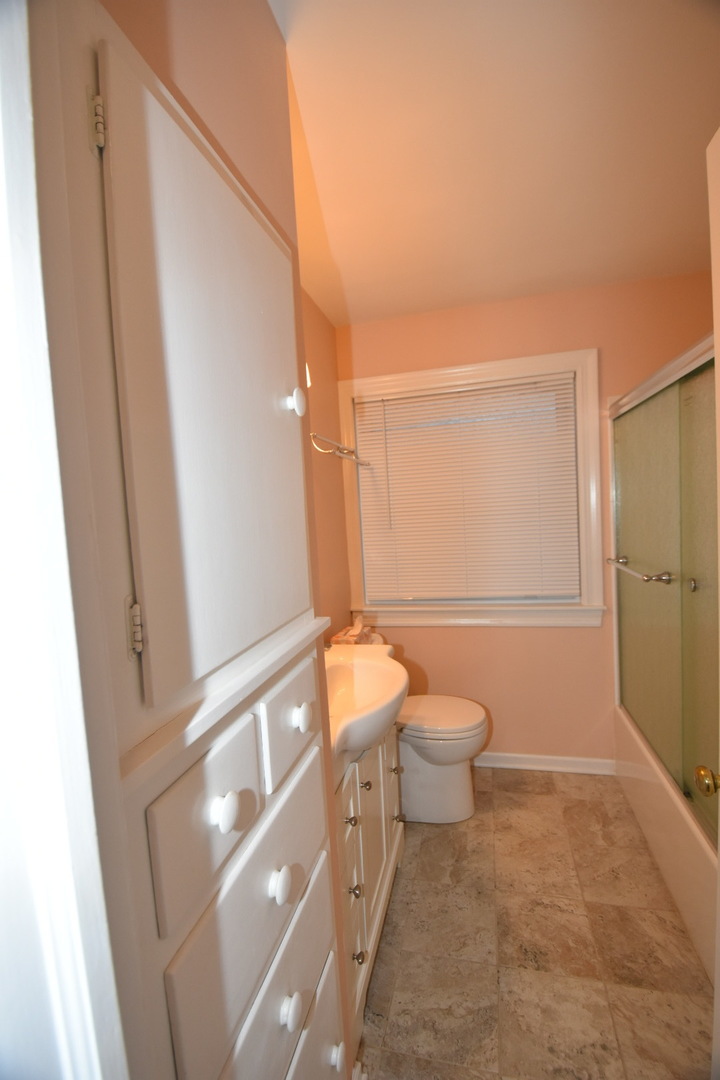 111 West Prairie Avenue Wheaton, IL 60187 - Photo 13 of 24 a bathroom with a toilet a sink and shower