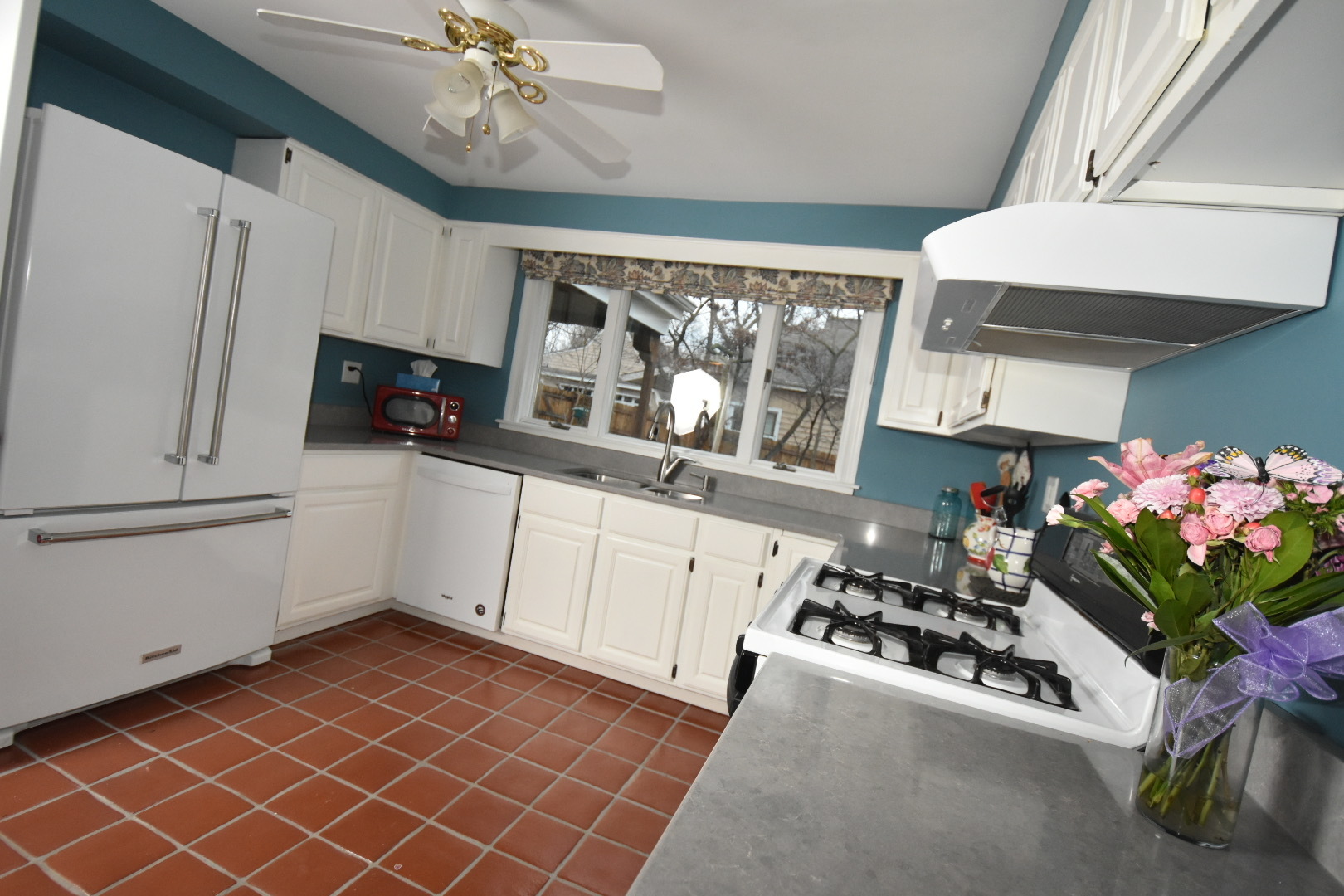 111 West Prairie Avenue Wheaton, IL 60187 - Photo 3 of 24 a kitchen with stainless steel appliances a sink a stove a refrigerator cabinets and a dining table