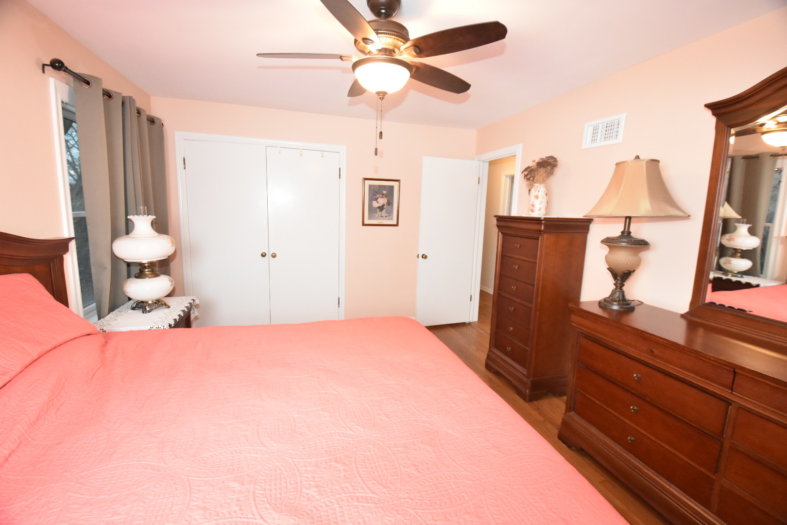 111 West Prairie Avenue Wheaton, IL 60187 - Photo 8 of 24 a bedroom with a bed and a mirror on the dresser