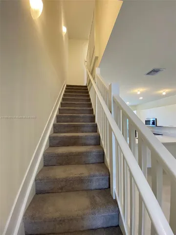 a white toilet sitting next to a sink